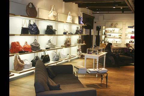 Contemporary back-lit shelves house handbags